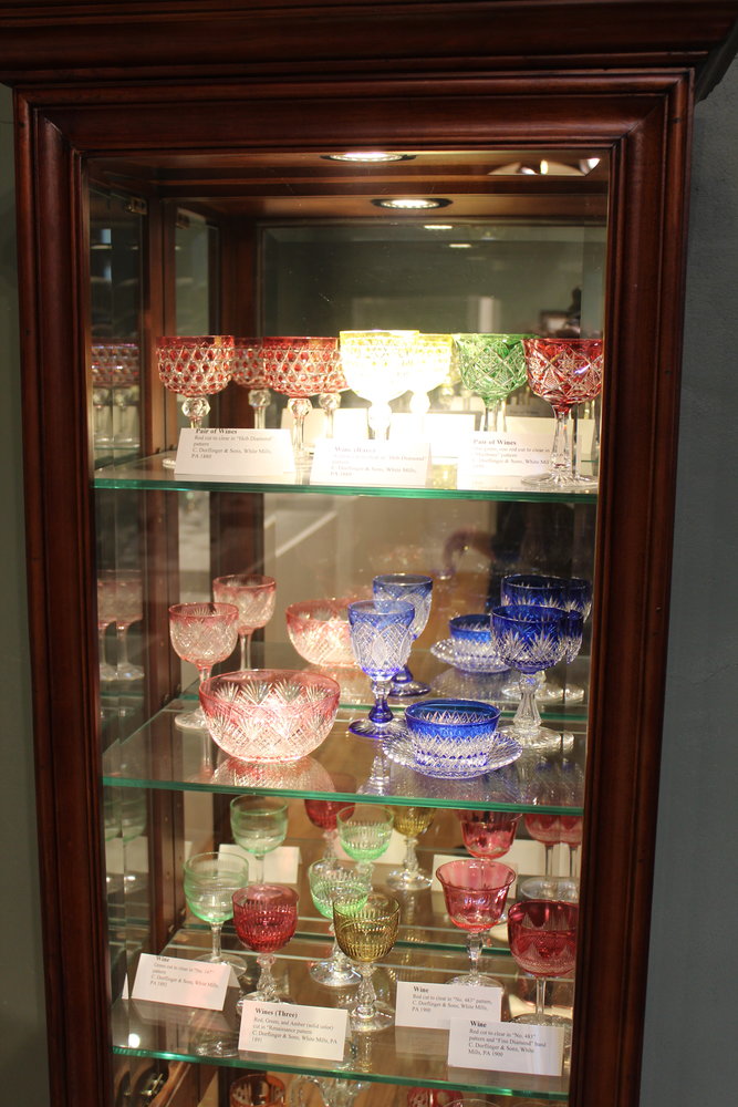 A display of glassware samples at the Dorflinger Factory Museum. The samples were kept on hand in case a broken glass in a set needed to be replaced.